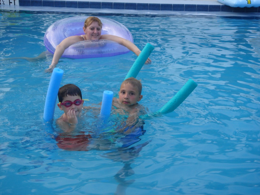 family of three in swimming pool