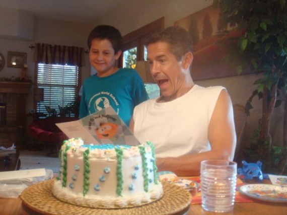 Dad making big surprised face after opening young Son's birthday card