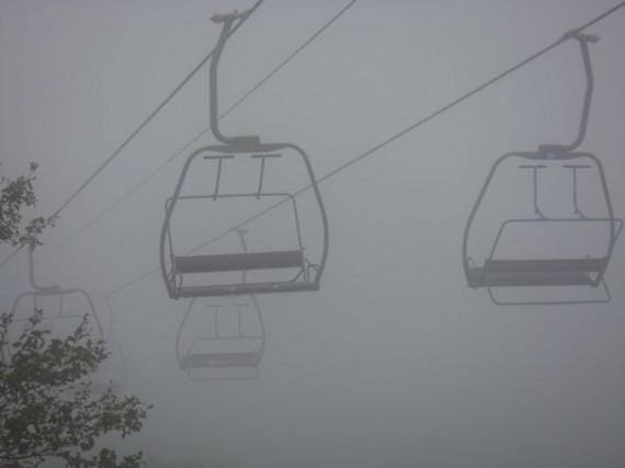 empty ski lift chairs in New York mountains's fog