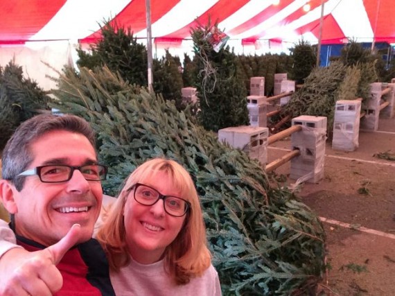 happy couple buying Christmas tree in Orlando