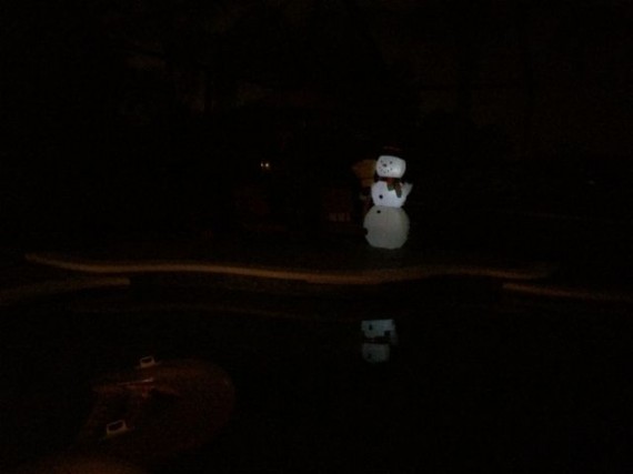 Inflatable snowman at night on pool deck