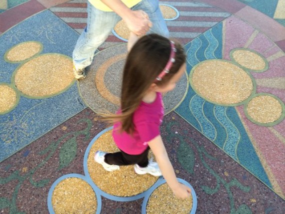 Small child at Disneyland entrance compass