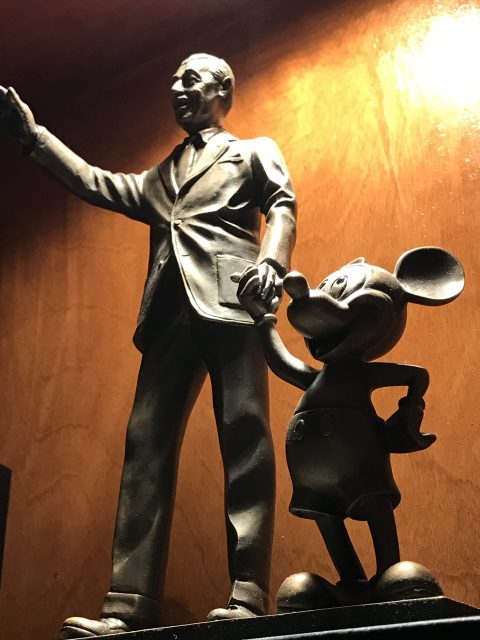 Walt Disney Partners statue on bookshelf