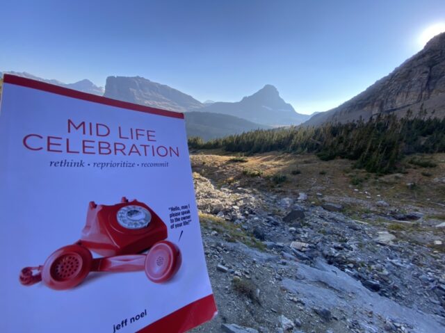 Mid Life Celebration, the book, with mountains in the background