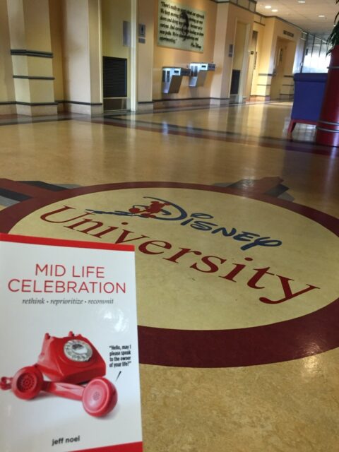 The book Mid Life Celebration at Disney University lobby