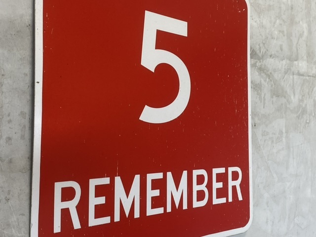 red sign with number 5 and the word remember