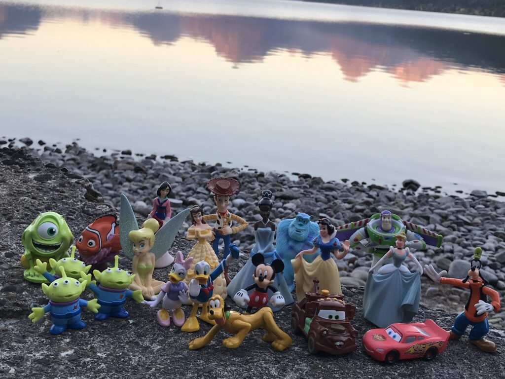 Small Disney figurines at lake