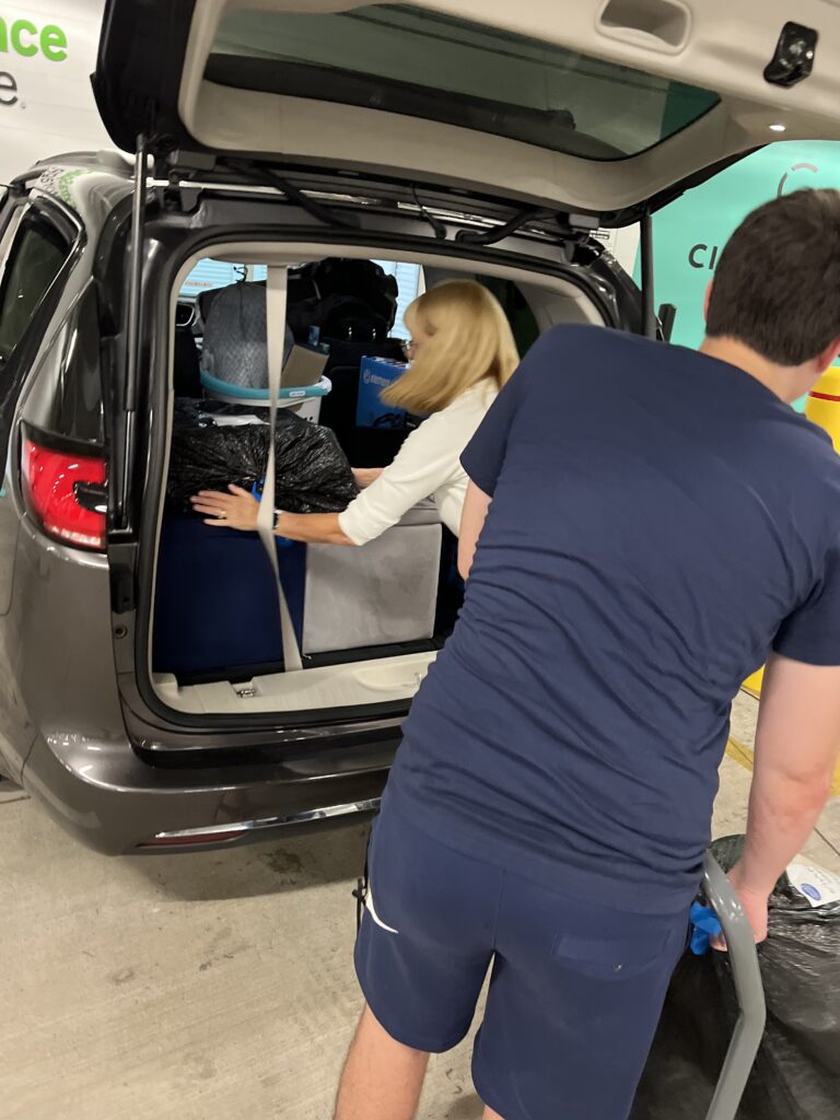 Two people loading a van