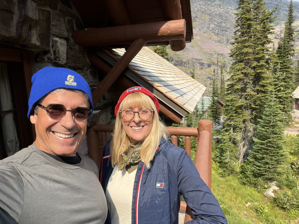 A couple standing on a mountain chalet balcony