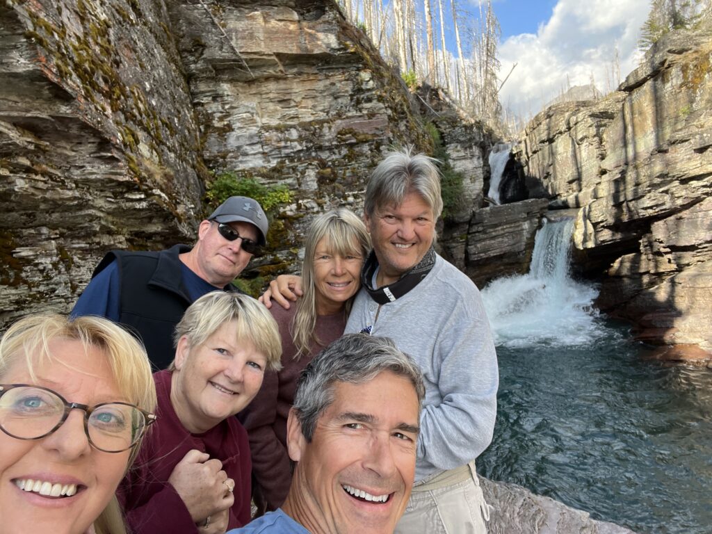 Six people at a waterfall