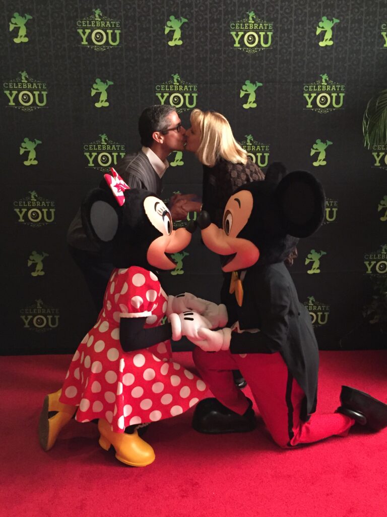 couple posing with Mickey and Minnie Mouse
