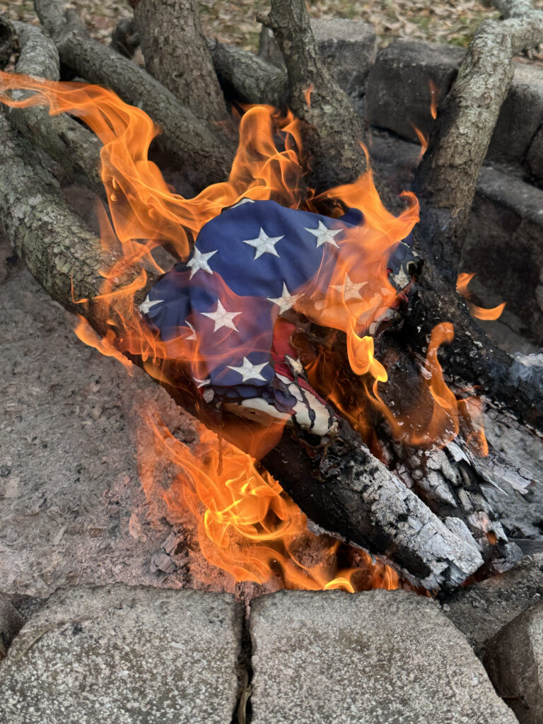 flag being burned in a fire