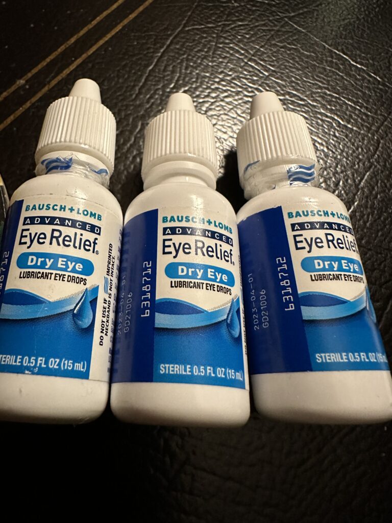 three small bottles of eye drops