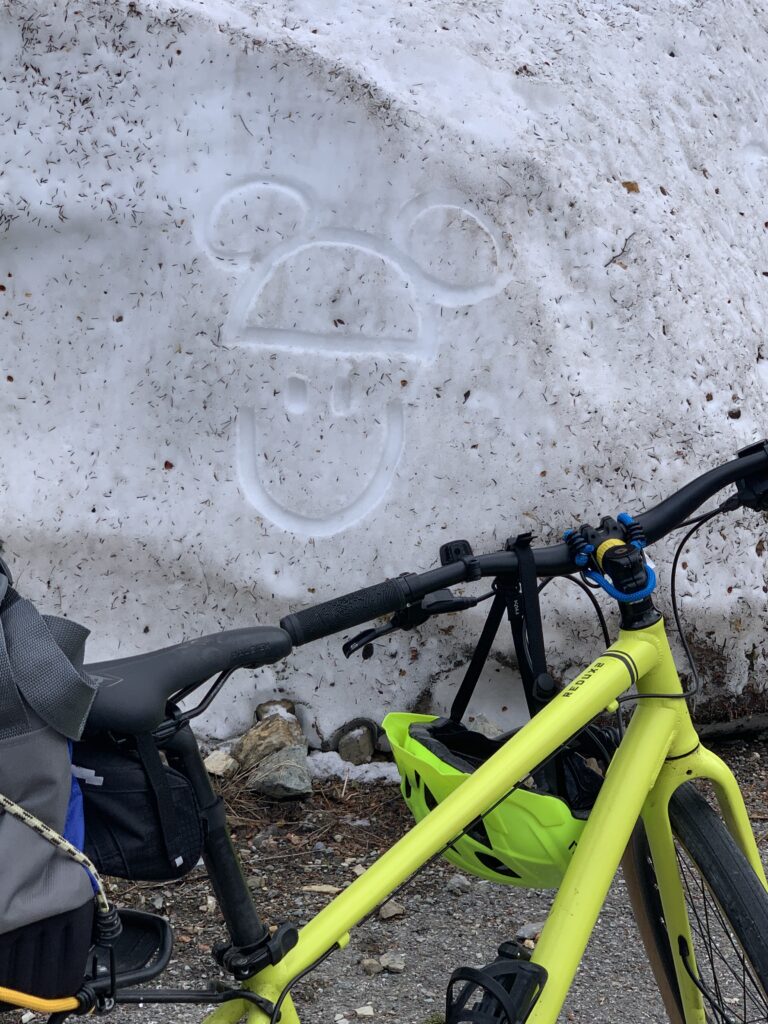 Snowbank, bicycle, and smiley face 