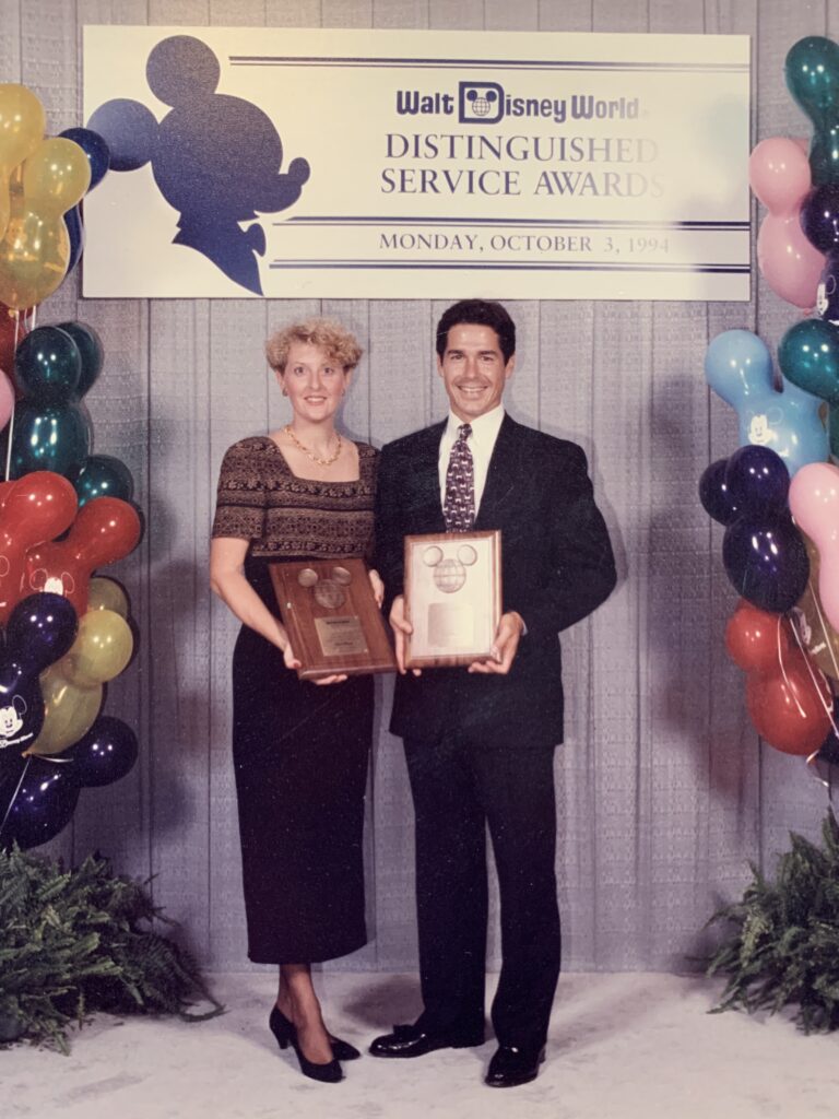 A Disney couple receiving their 10-years of service awards