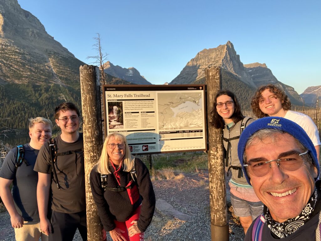 Family at National Park trailhead sign