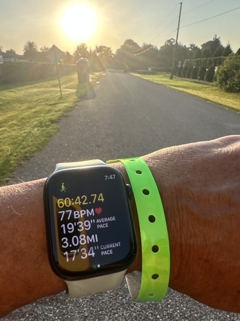 Apple Watch fitness screen on  a rural Road