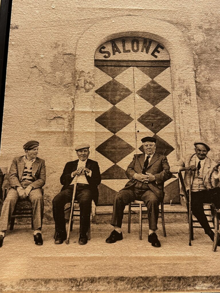 Four men sitting on chairs