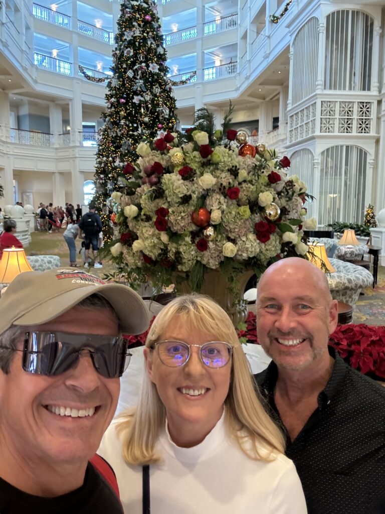 Three adults in a Disney hotel lobby