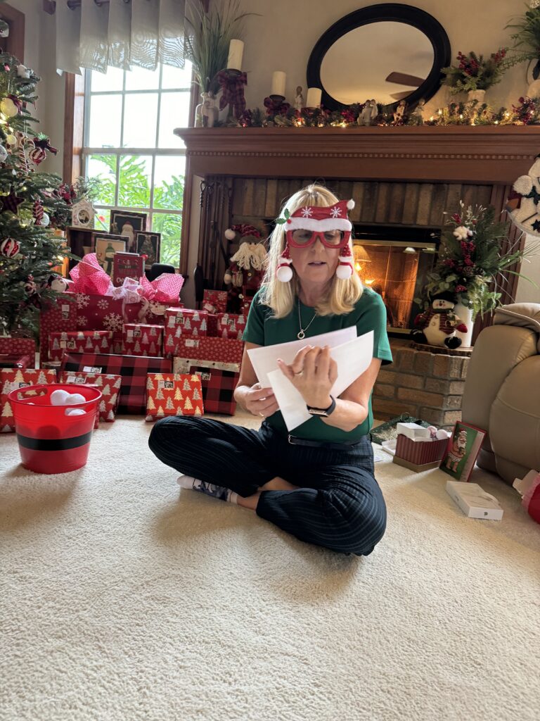 Woman with festive attire next to a Christmas tree