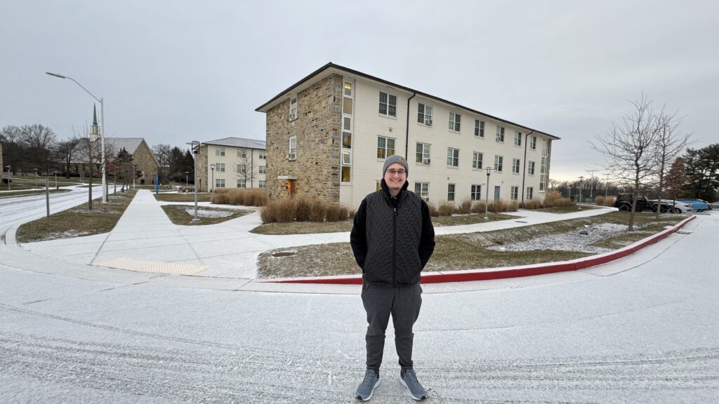 College student by deserted and snow covered campus