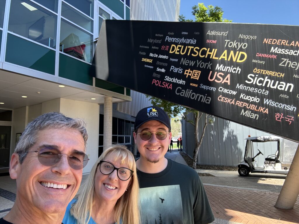 Family posing next to Unique college campus design