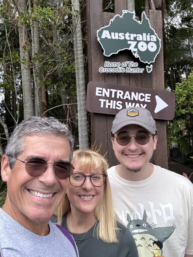 Three adults at a zoo