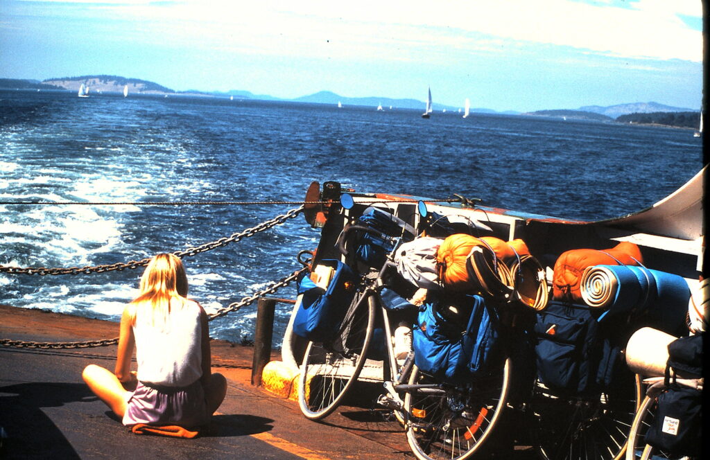 Woman sitting on a ferry boat next to bicycles