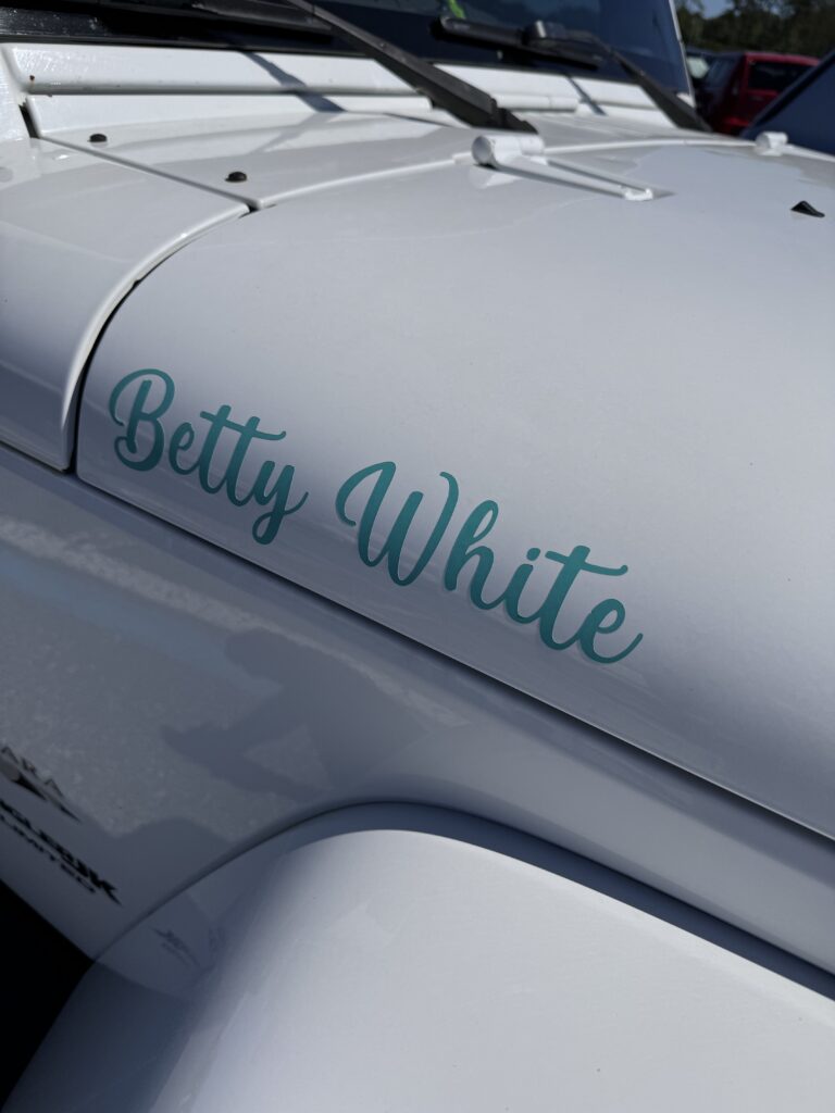 Betty White decal on a white vehicle