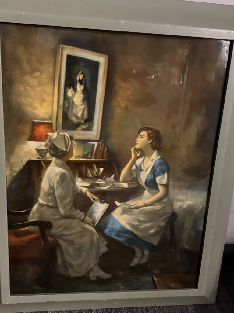 Painting of two nurses staring at a painting of Florence Nightingale