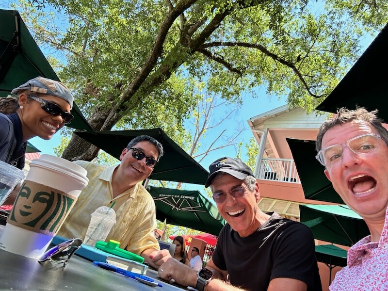 Four people at an outdoor Starbucks