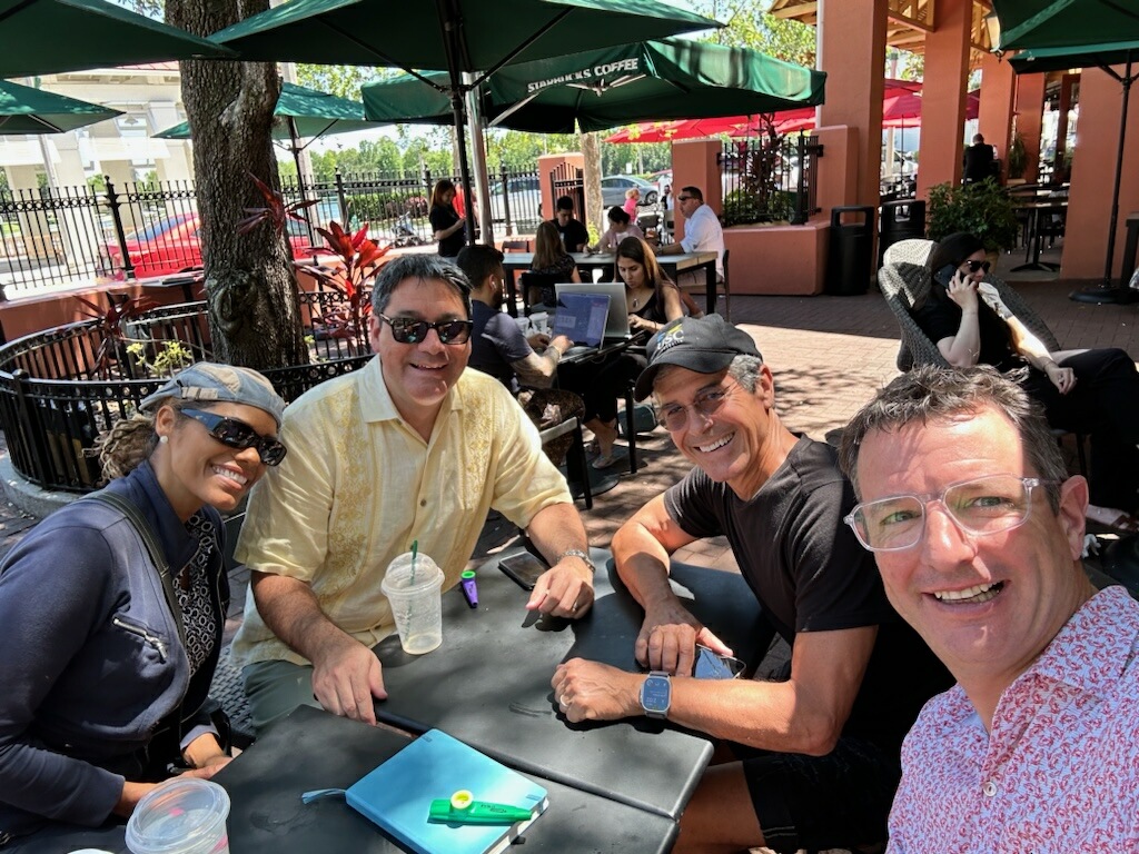 Four people at an outdoor Starbucks