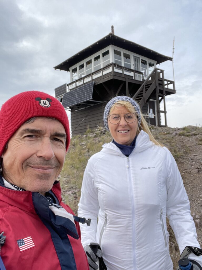 two people at a mountain fire-tower