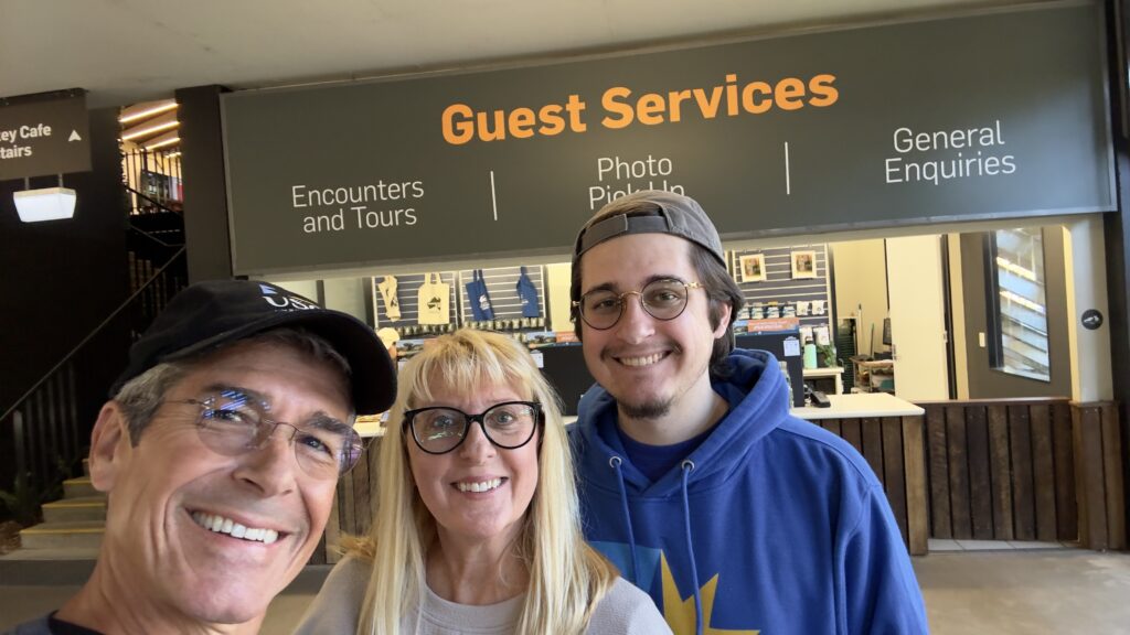 three adults at guest services desk