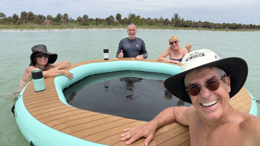 four seniors on a large swim raft